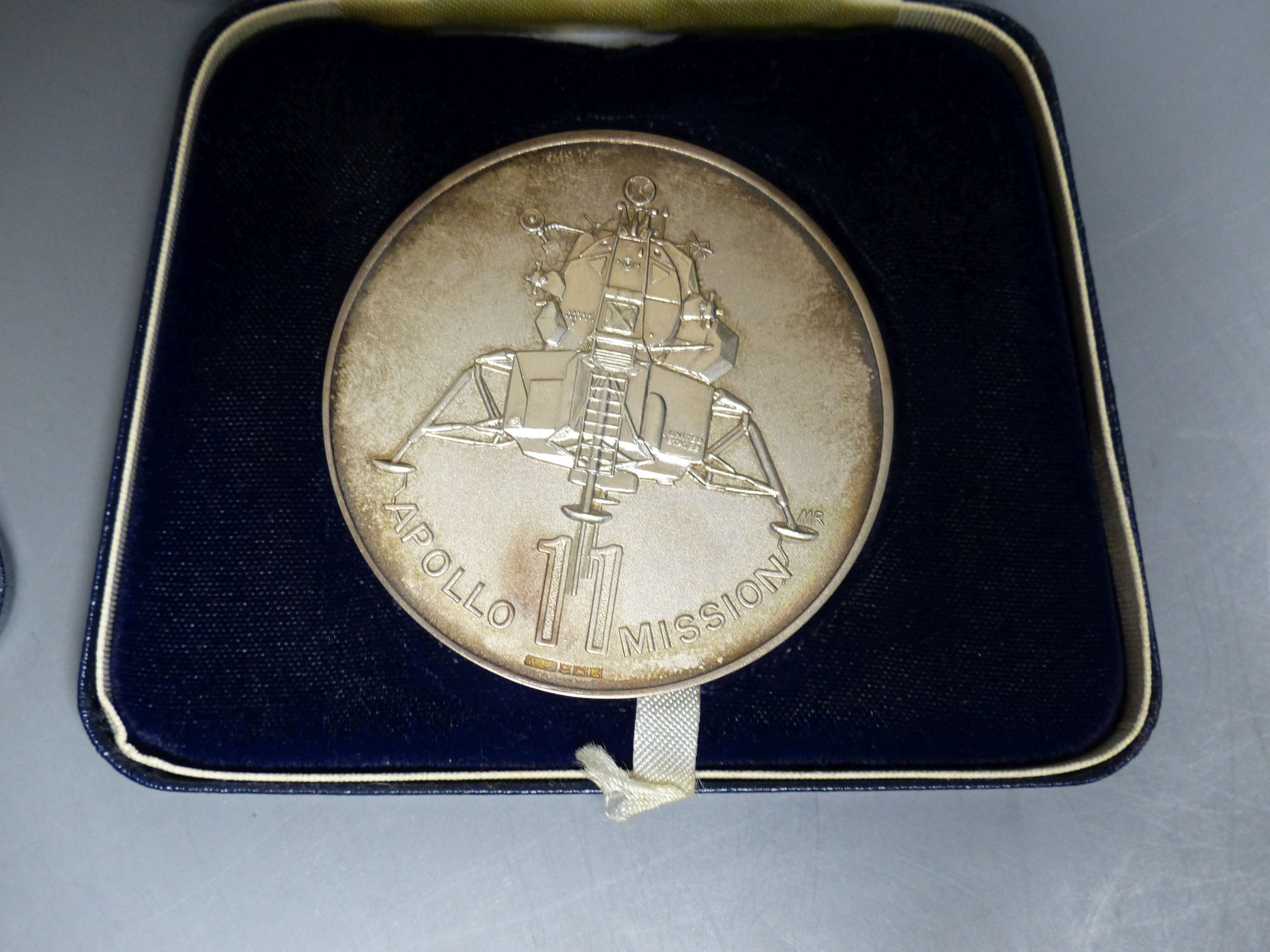 Two sterling silver limited edition 'Man's First Moon Landing' commemorative medals, cased